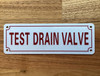 TEST DRAIN VALVE COMPLIANCE SIGN