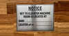 notice-key-to-elevator-machine-room-is-located-at-aluminum-door-sign.jpg