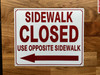 sidewalk-closed-use-pedestrian-walkway-arrow-left-sign-wb-red-as-listed-equipment-notice.jpg