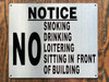 NO SMOKING DRINKING LOITERING SITTING IN FRONT OF BUILDING SIGN NO SMOKING DRINKING LOITERING SITTING IN FRONT OF BUILDING SIGN