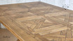 Close-up of the table's top, highlighting the smooth texture and natural oak finish