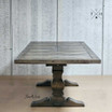 Front view of the extendable dining table showcasing its stunning silhouette and pedestal base