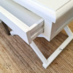 Image of the bedside table with the drawer open, showcasing the ample storage space.