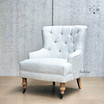 Detailed and Angled Front View of Avery Armchair: Focused on tufted buttons and fabric texture