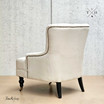 Rear Perspective of Avery Armchair: Elegant scooped back design in natural linen blend upholstery