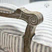 Close-up on the intricate timber carving details of the french armchair