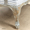 Image focusing on the French provincial style solid timber carved legs of the armchair