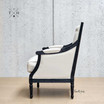 Profile of the armchair, emphasizing the black oak leg design