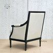 Rear angle showcasing the tufted back and elegant black oak frame