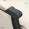 Detailed image of the armchair's armrest in natural linen.