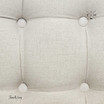 Detailed close-up showing the sophisticated tufting on the natural linen fabric