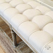 Zoomed-in view of the tufted linen upholstery, showing quality craftsmanship