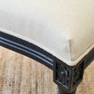 Side angle focusing on the edge of the upholstered seat, showcasing the chair’s attention to detail