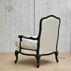 Rear angle showing the intricate back design of the upholstered armchair