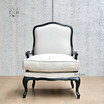Frontal perspective of Cannes Louis Upholstered Armchair in natural linen with black frame