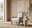 Thomas and Hurley Cannes occasional French-inspired linen armchair with black painted frame resting on a textured woven jute rug styled with a round side table
