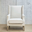 Front angle of the Brereton Occasional Wingback Chair in cream linen without backrest cushion, highlighting silhouette