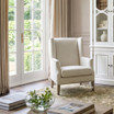 Classic cream linen wingback armchair in a warm minimalist living room