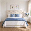 A front view of a tufted buttoned-back linen queen-sized headboard in cream linen, shown in a blue and white Hamptons bedroom setting.