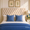 A linen buttoned-back queen-sized cream headboard showing its texture in an elegant Hamptons inspired setting.