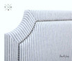 ide view of the headboard, illustrating the depth and profile of the upholstered design and the the embedded stud trim detail surrounding the hamptons headboard