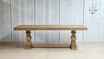 Full-length view of the side of the Bedford Oak Dining Table, showcasing the parquetry and apron detail