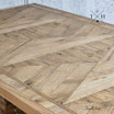 Diagonal view across the table top, showcasing the detailed oak parquetry