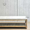 Side view of the ottoman, showcasing the hand-carved weathered oak frame, perfect for lounge rooms