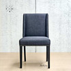 Front view of the Lumley Dining Chair, showcasing its elegant winged back design and sophisticated brass stud detailing.