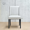Front view of the Lumley Dining Chair, showcasing its elegant winged back design and sophisticated brass stud detailing
