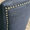 Detailed close-up of the chair's backrest, highlighting the traditional button tufting that adds classic charm