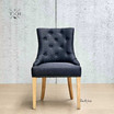 Full frontal view of the Braddock Tufted Dining Chair, showcasing its elegant modern silhouette and crisp linen upholstery