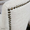 Close-up view focusing on the elegant curve of the chair’s linen backrest, designed for comfort and support
