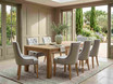 Designer dining chair in natural upholstery by Thomas and Hurley styled in a light-filled luxury dining room with contemporary coastal influences.