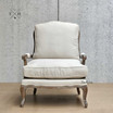 Front perspective of the Cara Occasional Armchair, showcasing natural linen upholstery.