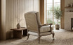 Luxury occasional armchair with weathered oak frame and woven rattan back by Thomas & Hurley