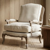 Premium accent armchair with natural linen cushions and woven rattan back by Thomas & Hurley