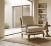Hamptons style accent chair with carved oak legs and natural rattan backrest