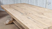 The Charlested Oak Dining Table bathed in sunlight, enhancing the rich, natural color of the wood