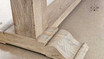 Image focusing on the robust pedestal legs of the Charlested Oak Dining Table, illustrating their solid build and elegant design.