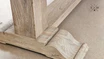 Image focusing on the robust pedestal legs of the Charlested Oak Dining Table, illustrating their solid build and elegant design.