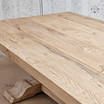 Detailed close-up of the Charlested Oak Dining Table surface, highlighting the natural oak grain and unrefined finish