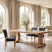 Luxury oak dining table by Thomas and Hurley with architectural pedestal legs, natural timber finish, and elegant contemporary appeal.