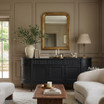 Front facing view of the Louis Curved Buffet in black in 200cm in a modern layered livingroom with mirror above