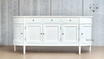 Frontal perspective of the Louis Buffet focusing on the symmetrical arrangement of its grooved drawers, paired with the sleek, modern handles.