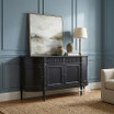 Angled view of the Louis Curved Sideboard in black in an elegant home