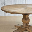 Close-up of the artisan-crafted Darcy Oak Round Table's parquetry and pedestal base, highlighting detail and quality.