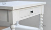 Angled view  of the Montclair Bedside Table showing the drawer detail, flat surface and paint stroke patina
