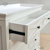 Side view with the drawer slightly open displaying the storage space of the Fremont 4 Drawer Chest and the metal runners