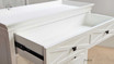 Angled front view with top drawer completely open displaying the storage space.
